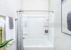 4519 Trinity Way, Unit THC1 Kissimmee, FL 34746 - Photo 9 of 14 a bathroom with a shower and a tub