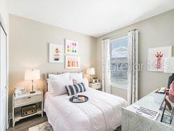 4519 Trinity Way, Unit THC1 Kissimmee, FL 34746 - Photo 10 of 14 a bedroom with a bed and a window