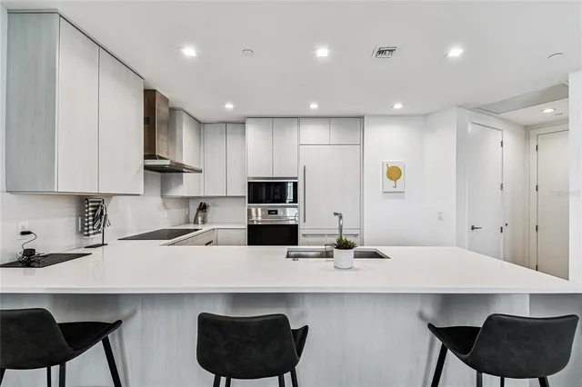 a bedroom with a bed and a large window with the outer view