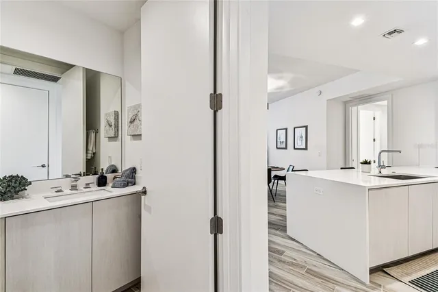 a bedroom with a bed window and a flat tv screen