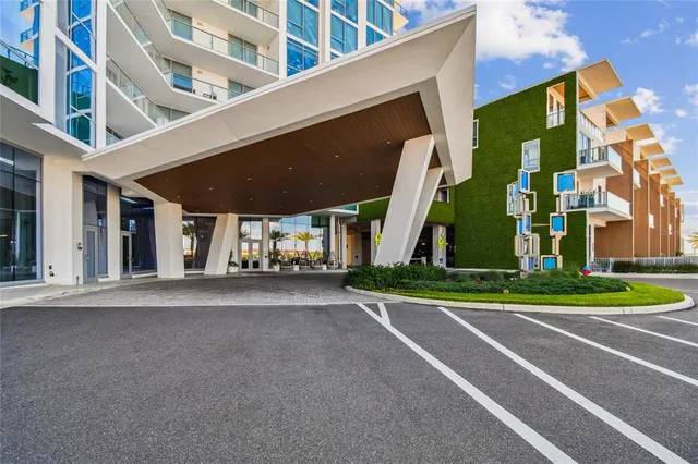 a room with a wooden floor and potted plant