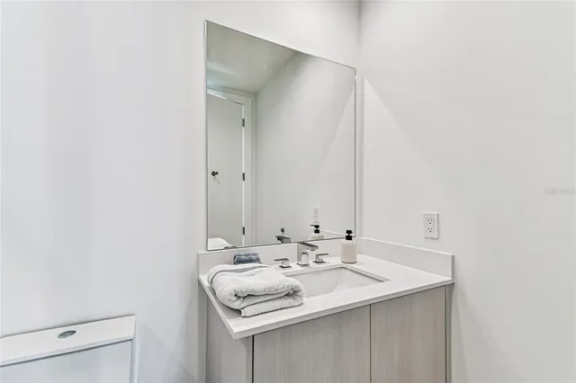 a view of a lake with a yard and potted plants