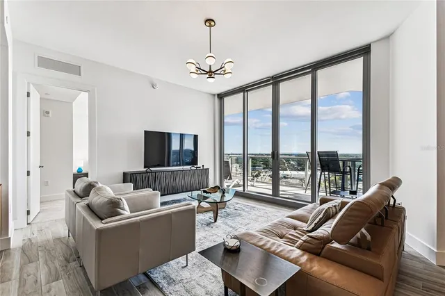 a living room with furniture and a chandelier