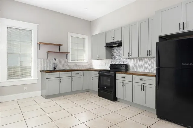 a kitchen with a sink appliances and cabinets