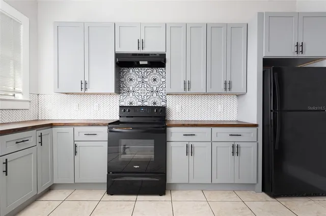 a kitchen with cabinets and appliances