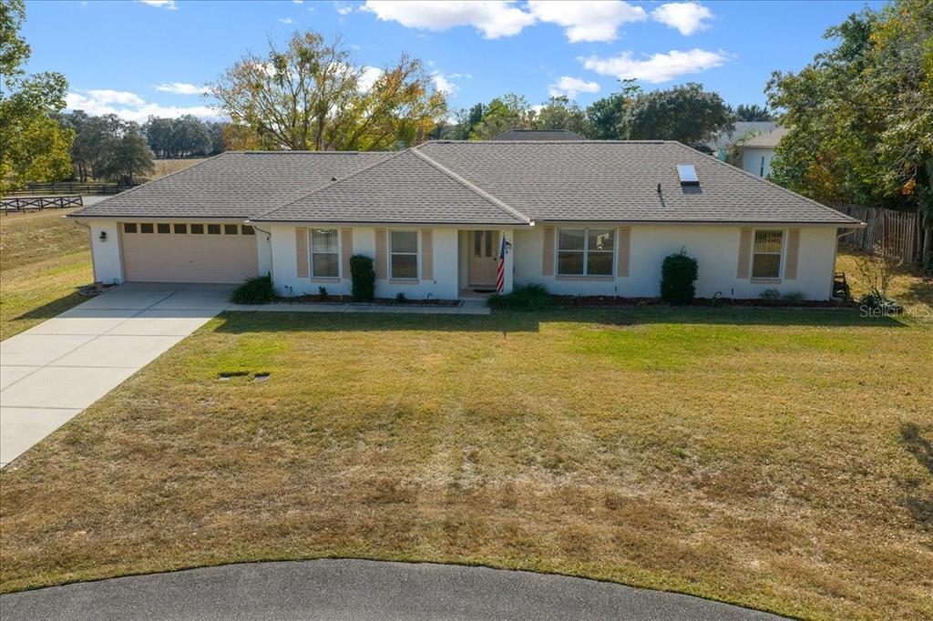 a aerial view of a house next to a big yard