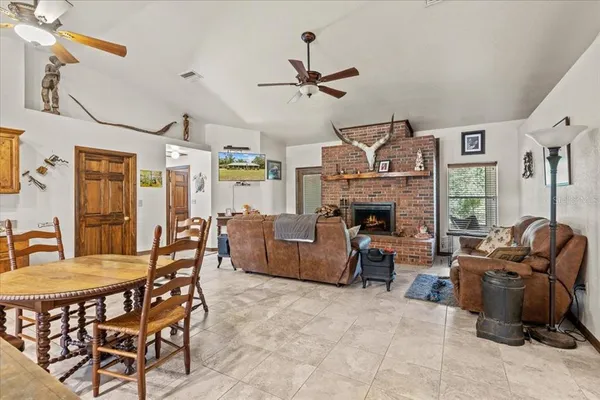 a living room with furniture a fireplace and a chandelier