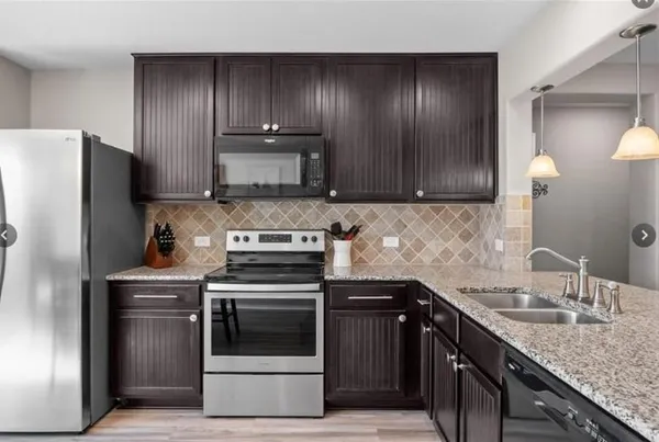 a kitchen with a sink stove and refrigerator