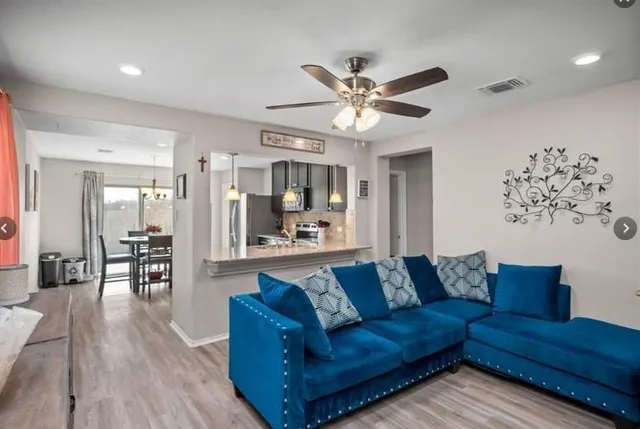 a dining room with furniture and a chandelier