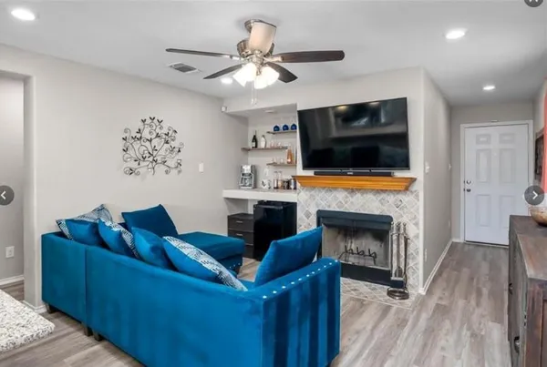a living room with furniture fireplace and flat screen tv