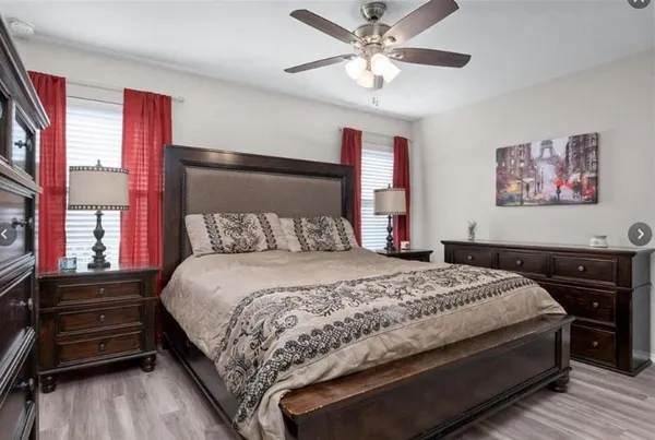 a bedroom with a bed and a chandelier