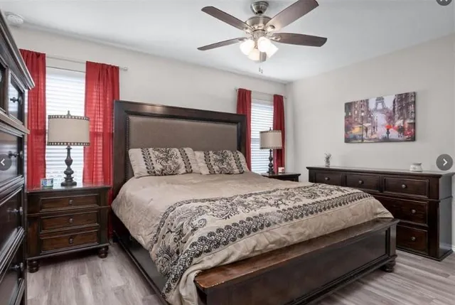 a bedroom with a bed and a chandelier