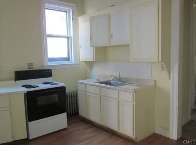 a utility room with sink dryer and washer