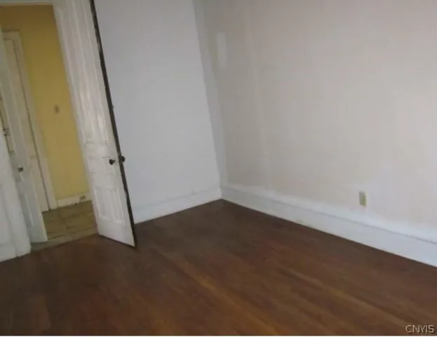 an empty room with a wooden door