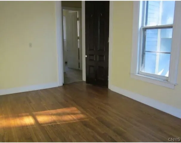 a view of an empty room with closet