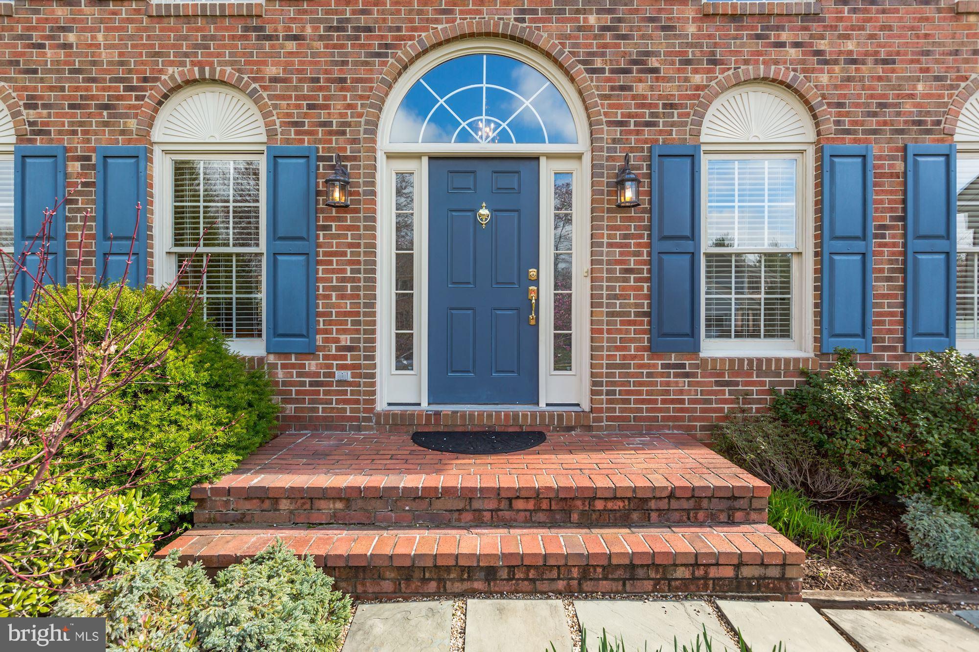 6402 Springhouse Circle Clifton, VA 20124 - Photo 2 of 43 a front view of a house with a garden