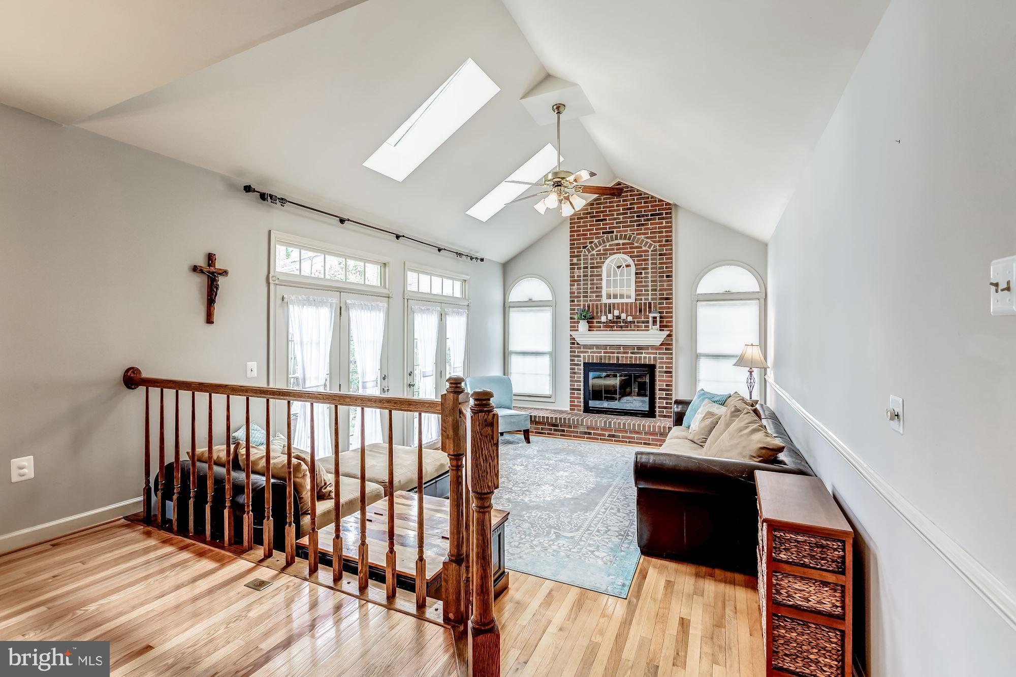 6402 Springhouse Circle Clifton, VA 20124 - Photo 13 of 43 a living room with furniture a fireplace and a chandelier