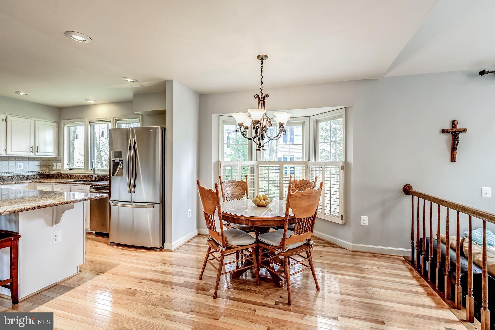 6402 Springhouse Circle Clifton, VA 20124 - Photo 18 of 43 a dining room with furniture a chandelier and wooden floor