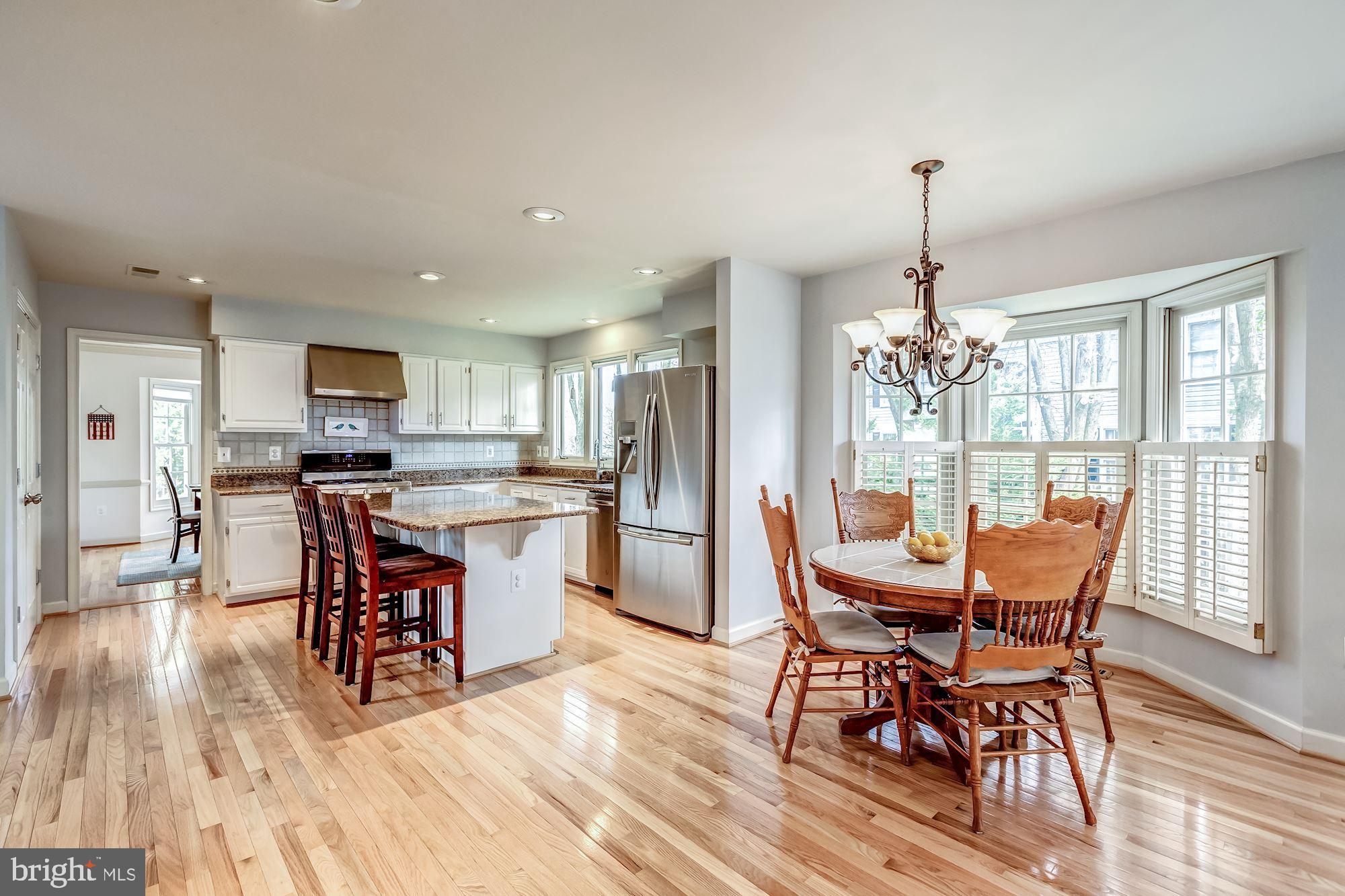 6402 Springhouse Circle Clifton, VA 20124 - Photo 19 of 43 a view of a dining room with furniture wooden floor and chandelier