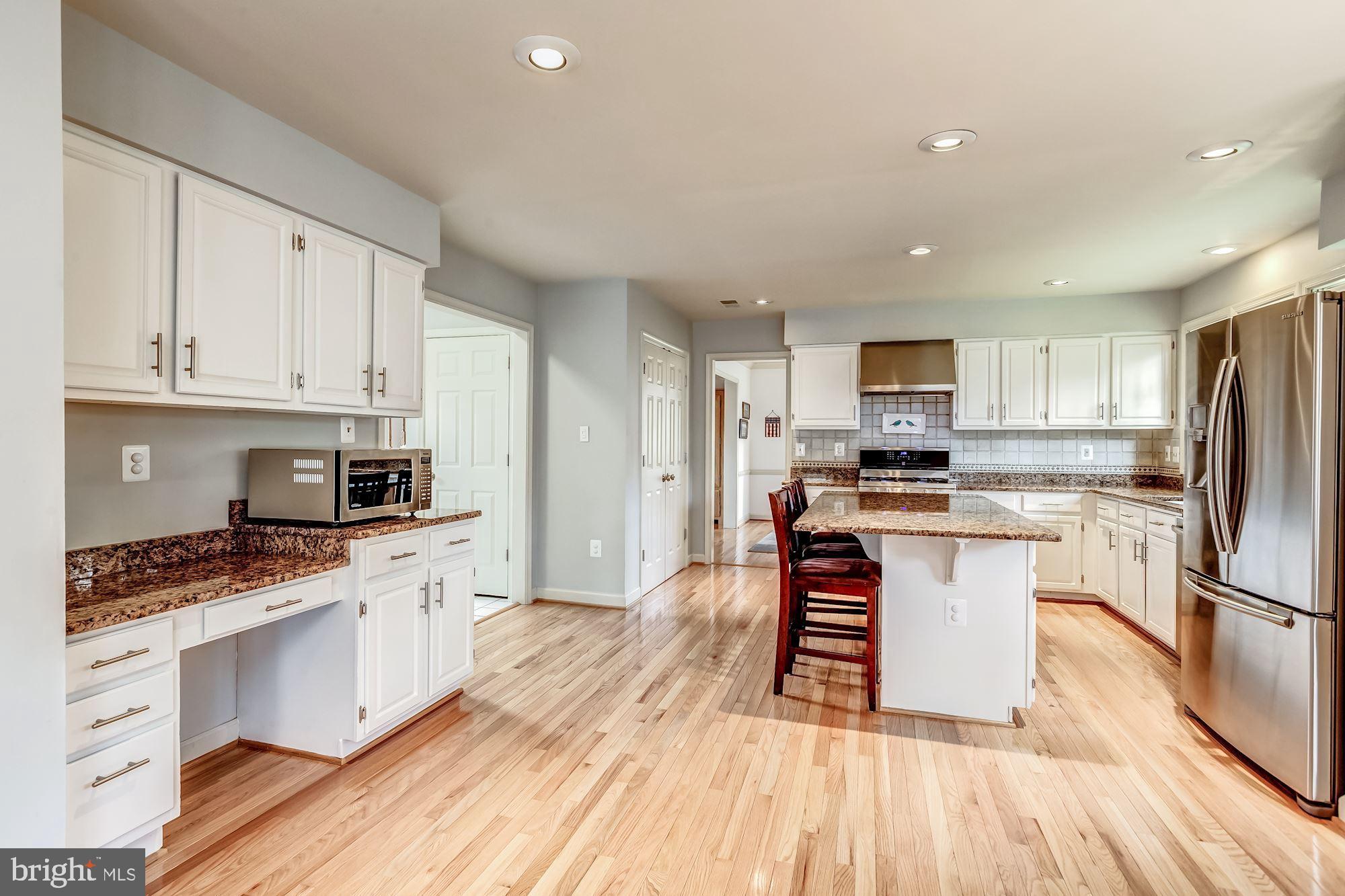 6402 Springhouse Circle Clifton, VA 20124 - Photo 20 of 43 a kitchen with white cabinets and appliances