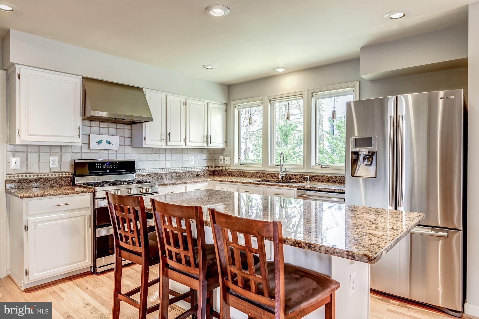 6402 Springhouse Circle Clifton, VA 20124 - Photo 22 of 43 a kitchen with stainless steel appliances granite countertop a stove a sink and a refrigerator