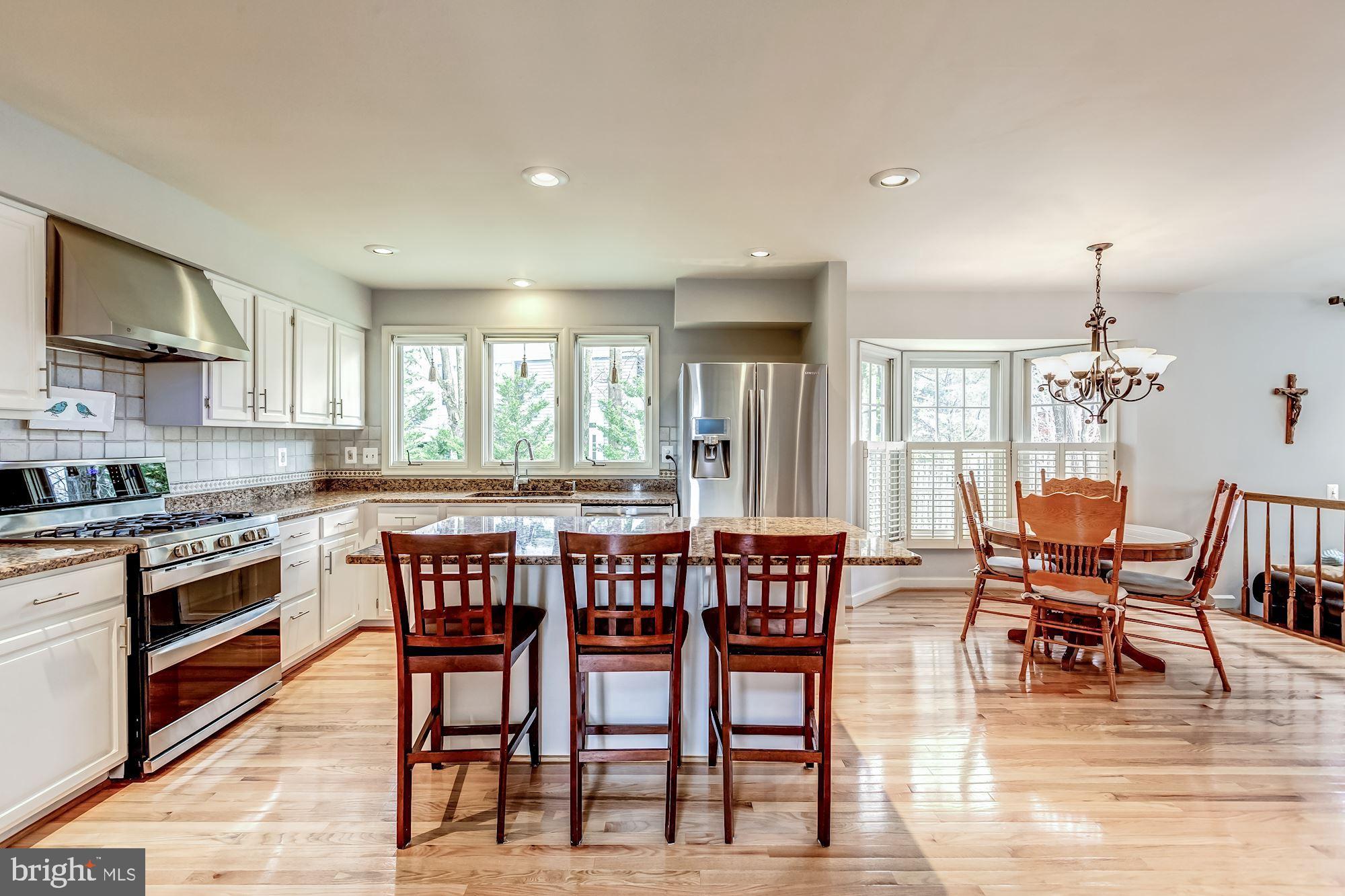 6402 Springhouse Circle Clifton, VA 20124 - Photo 24 of 43 a view of a dining room with furniture window and wooden floor