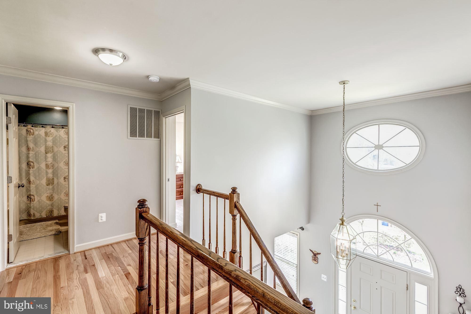 6402 Springhouse Circle Clifton, VA 20124 - Photo 26 of 43 a view of a livingroom with wooden floor and stairs