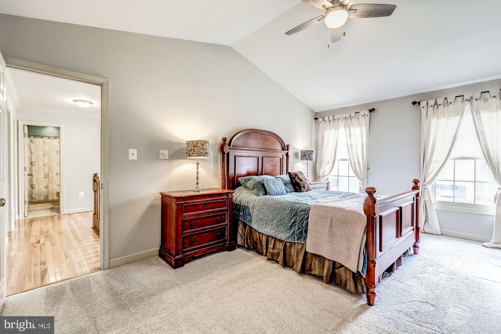 6402 Springhouse Circle Clifton, VA 20124 - Photo 27 of 43 a bedroom with a bed and a chandelier
