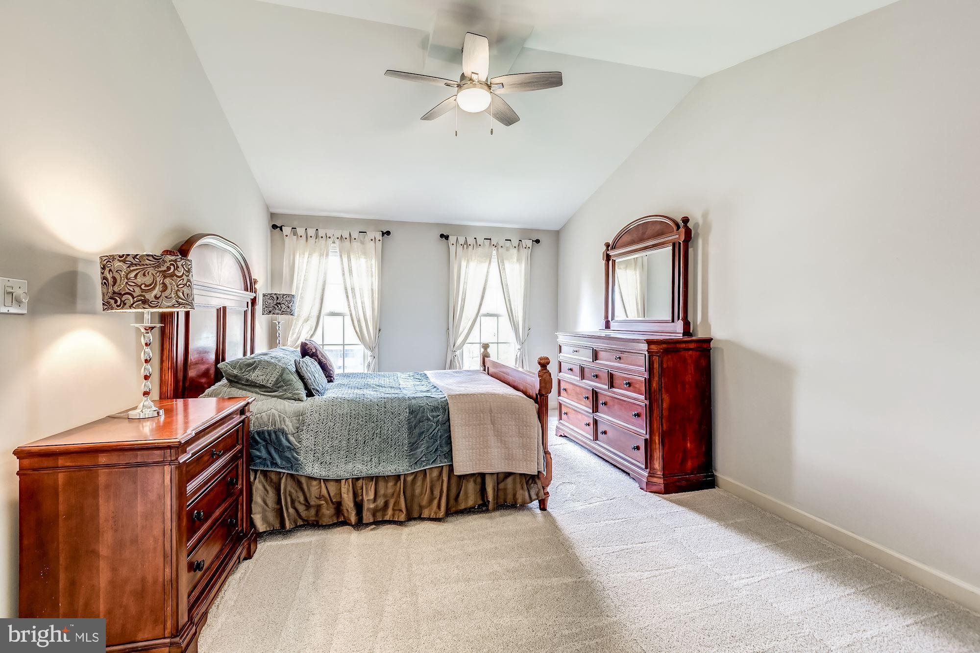 6402 Springhouse Circle Clifton, VA 20124 - Photo 28 of 43 a living room with furniture a chandelier and a flat screen tv