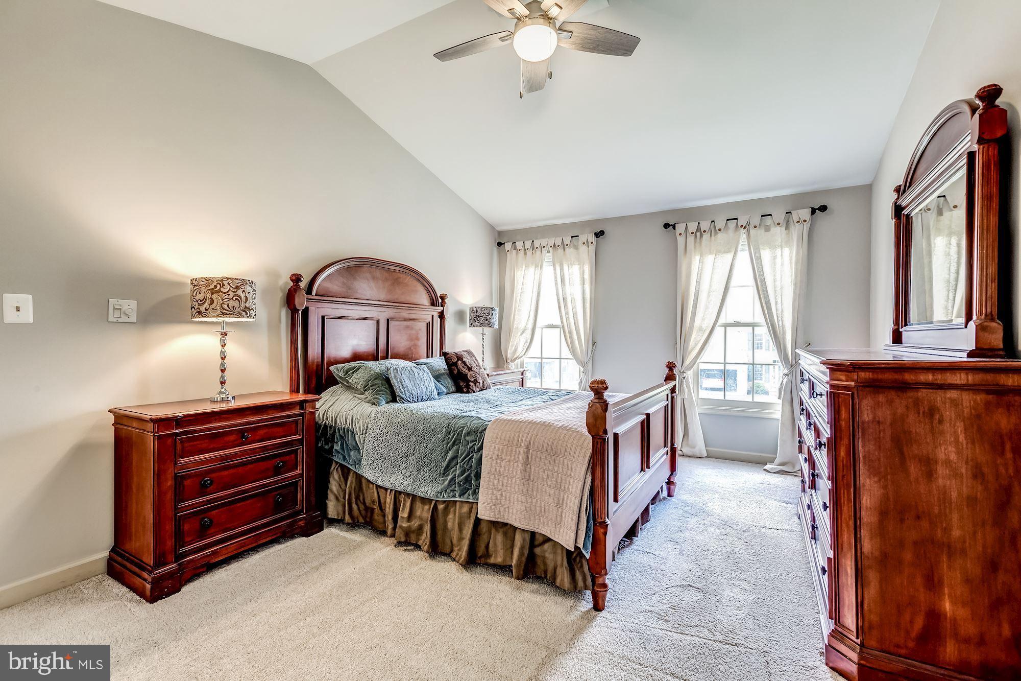 6402 Springhouse Circle Clifton, VA 20124 - Photo 29 of 43 a bedroom with a bed and a chandelier