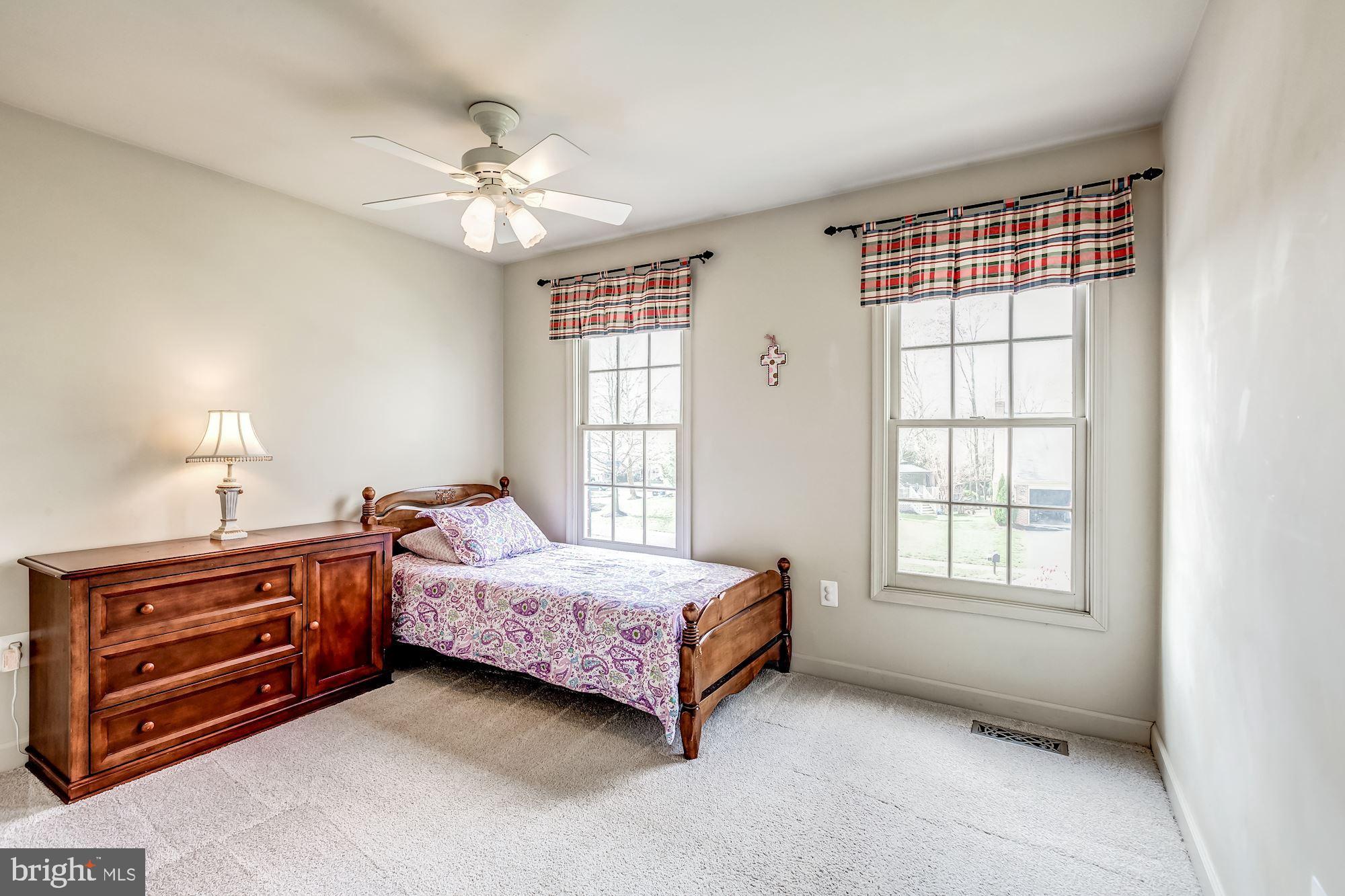 6402 Springhouse Circle Clifton, VA 20124 - Photo 33 of 43 a spacious bedroom with a bed and a chandelier