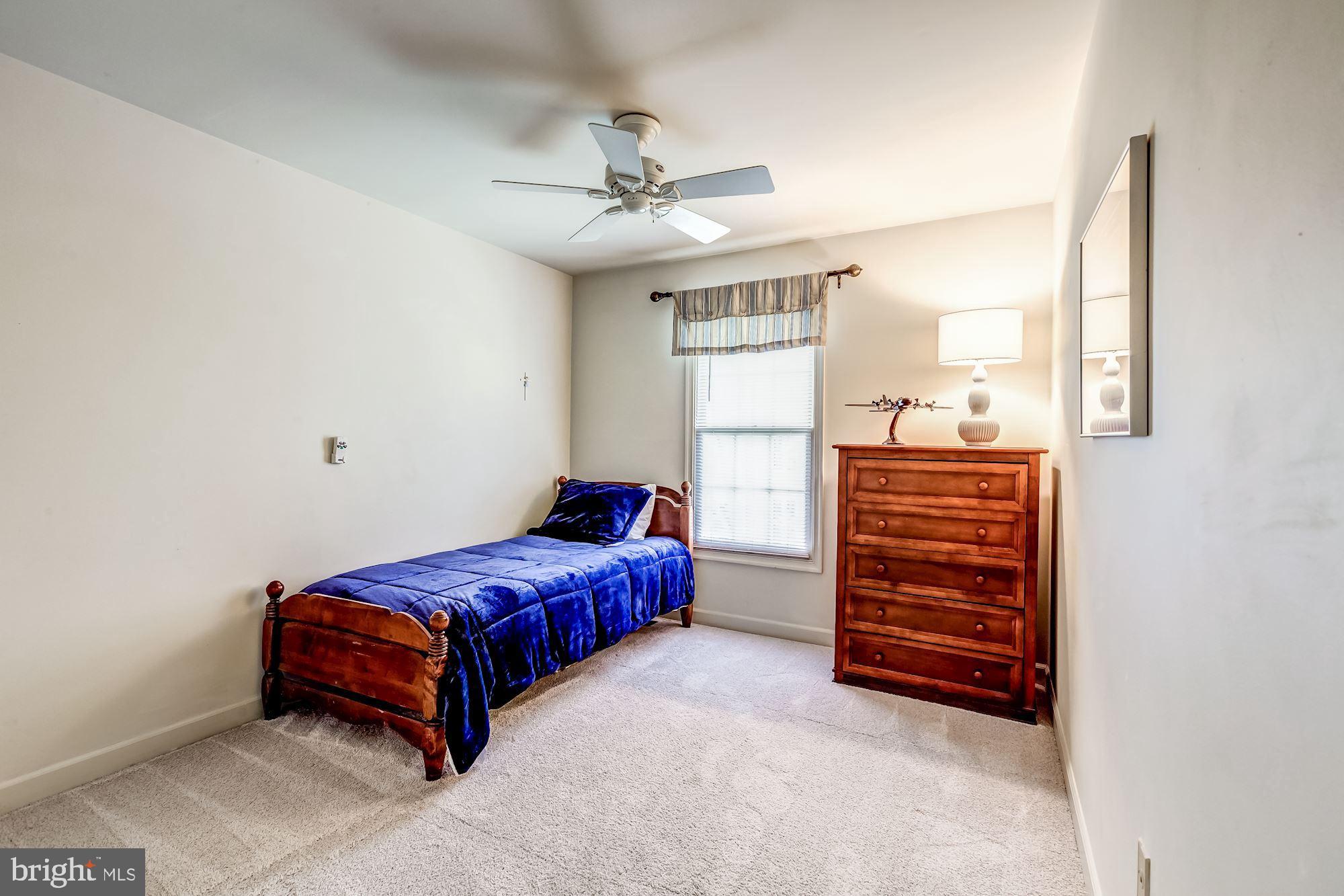 6402 Springhouse Circle Clifton, VA 20124 - Photo 34 of 43 a bedroom with a bed and a ceiling fan