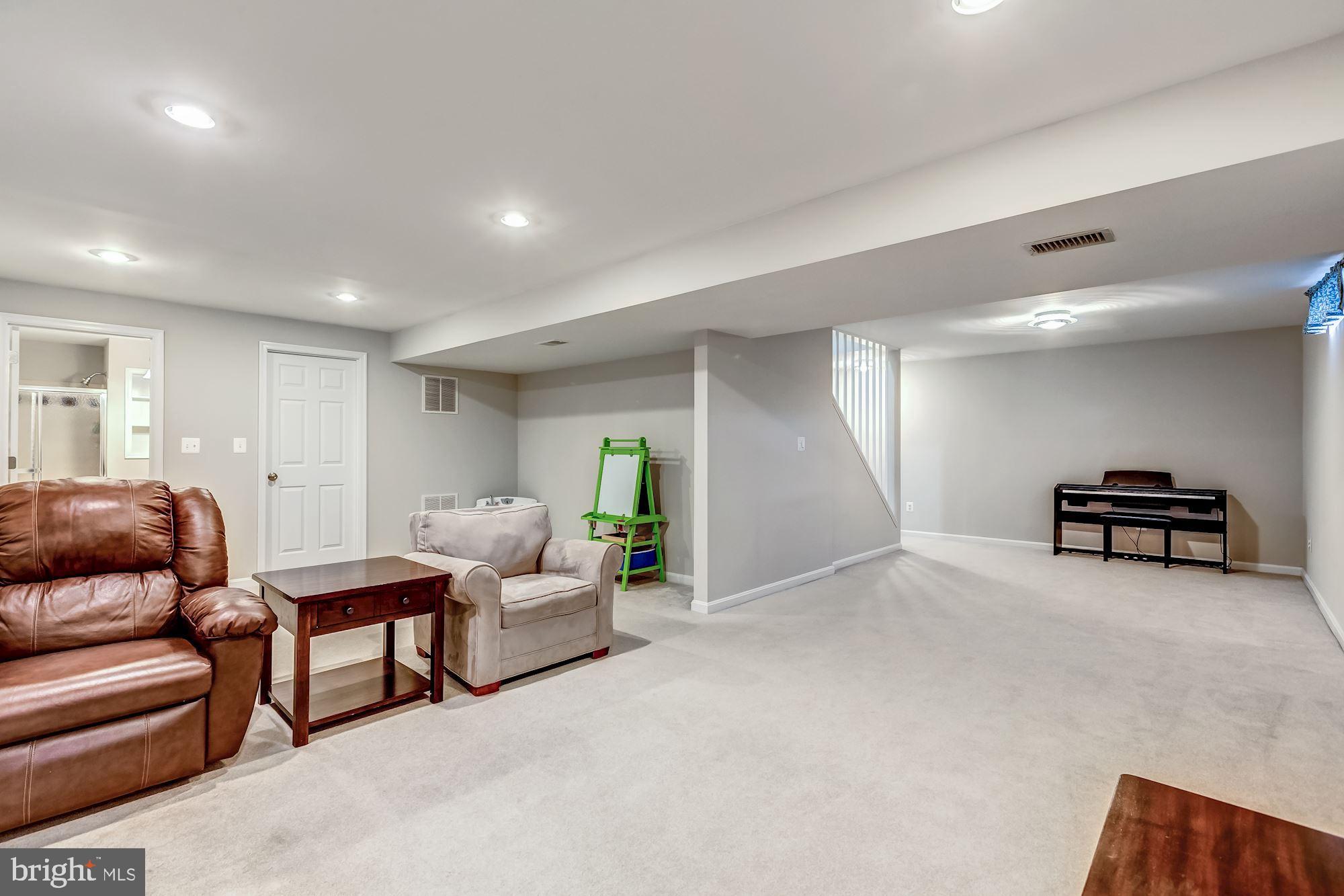 6402 Springhouse Circle Clifton, VA 20124 - Photo 37 of 43 a living room with furniture and a couch