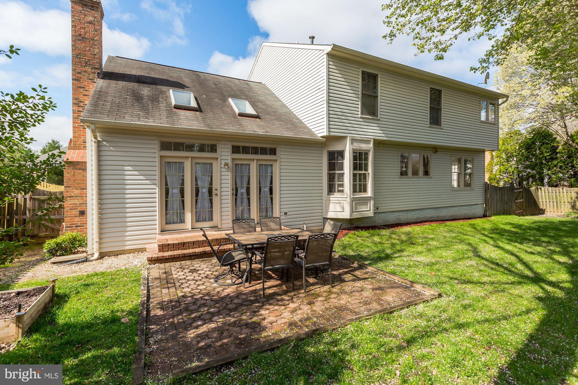 6402 Springhouse Circle Clifton, VA 20124 - Photo 41 of 43 a view of backyard of house with outdoor seating and covered with trees