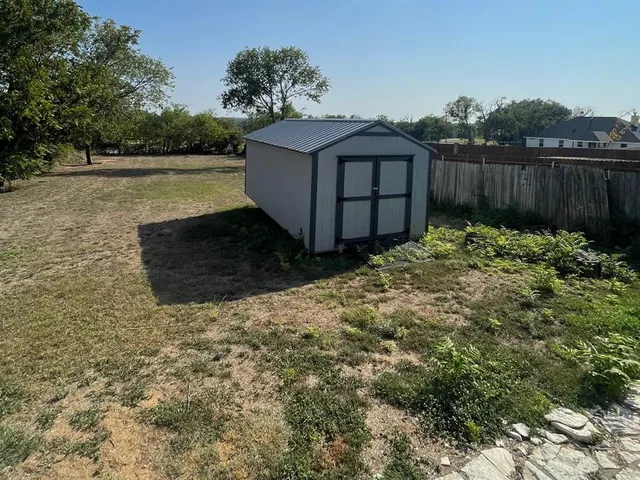 a view of a backyard with plants and lake view