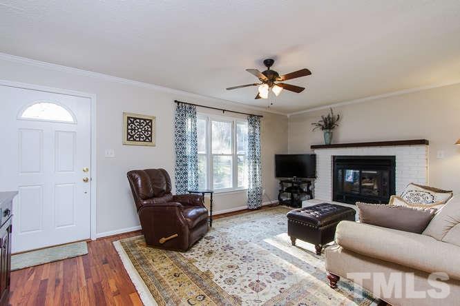 1100 Toppe Ridge Court Raleigh, NC 27615 - Photo 3 of 22 a living room with furniture and a flat screen tv
