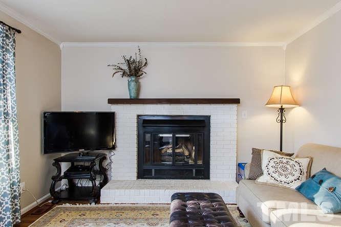1100 Toppe Ridge Court Raleigh, NC 27615 - Photo 4 of 22 a living room with furniture and a flat screen tv