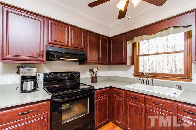 1100 Toppe Ridge Court Raleigh, NC 27615 - Photo 8 of 22 a kitchen with stainless steel appliances granite countertop a sink stove and cabinets