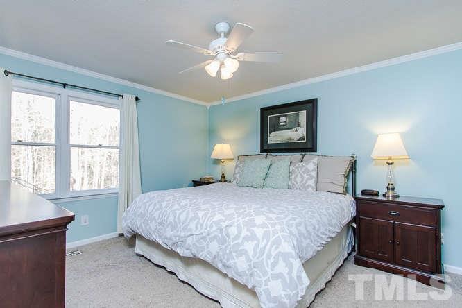 1100 Toppe Ridge Court Raleigh, NC 27615 - Photo 10 of 22 a bedroom with a large bed and a window
