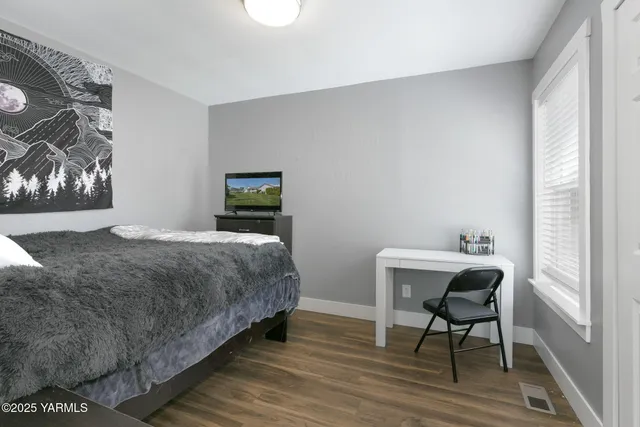 a bedroom with a bed and a table in it