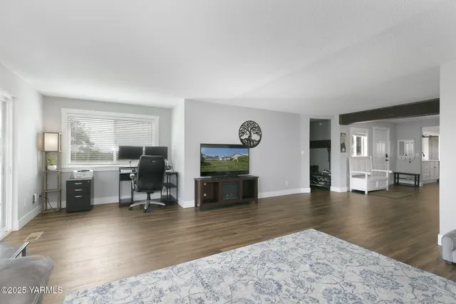 a view of a livingroom with furniture and a flat screen tv