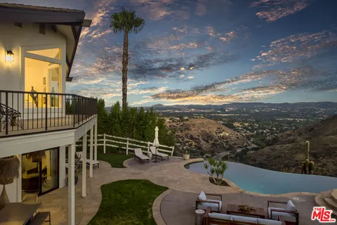 a view of a balcony with floor to ceiling windows and wooden floor