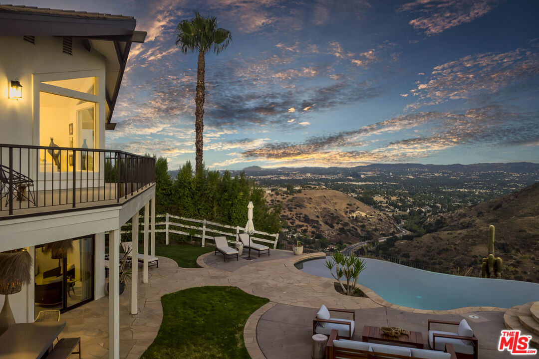 a view of a balcony with floor to ceiling windows and wooden floor