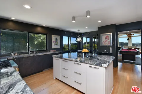 a large bedroom with a bed and furniture