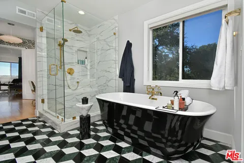 a bedroom with a bed a couch and dresser