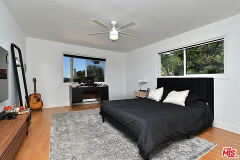 a room with furniture a flat screen tv and a window