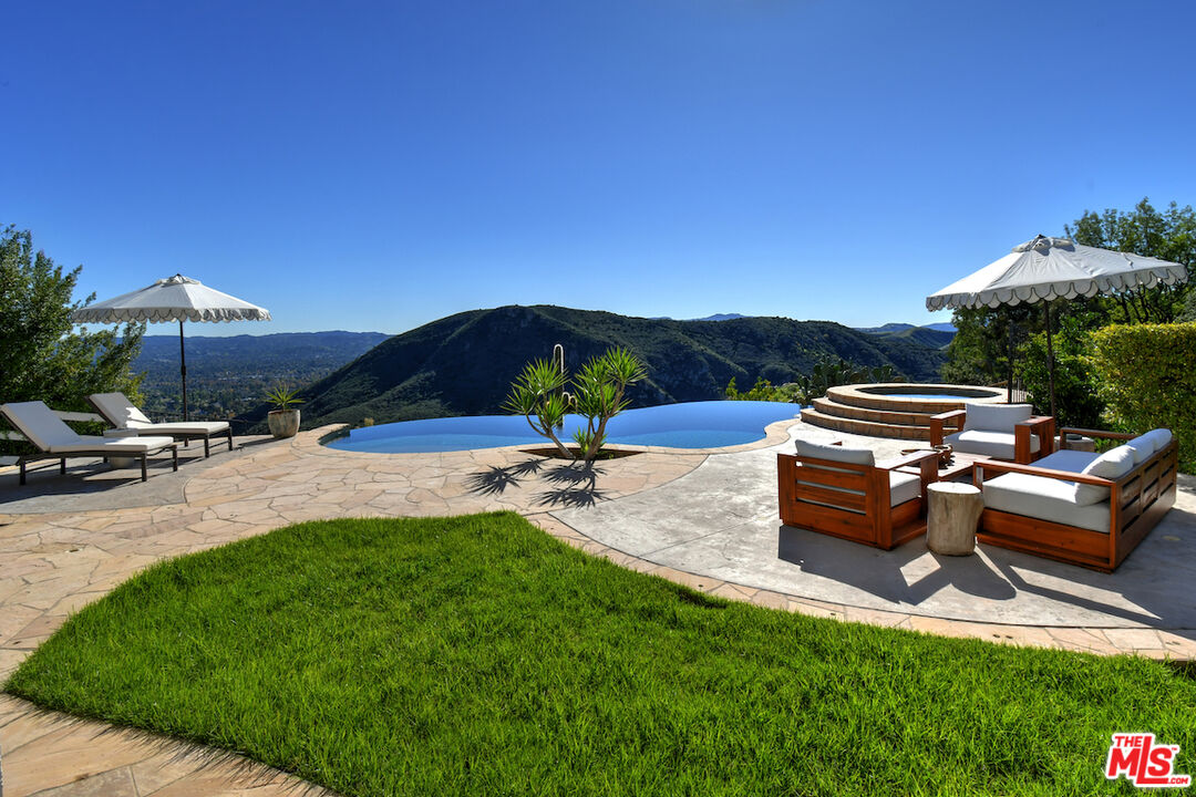 130 Dapplegray Road Bell Canyon, CA 91307 - Photo 36 of 48 a view of a patio with couches under an umbrella