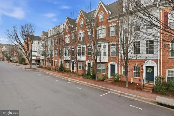 a view of a garden with a house in the background