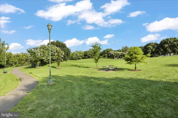 a picture of a bench in front of a wall