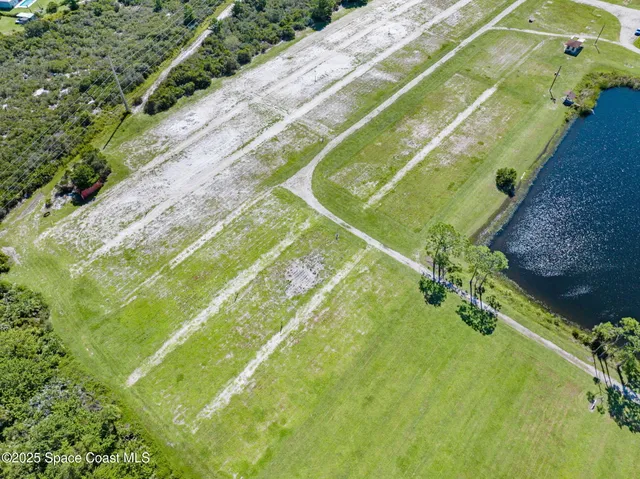 an aerial view of a house with garden space and street view